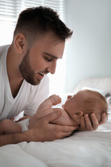 Poster - Father with his newborn son at home