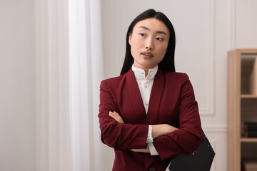 Canvas Print - Portrait of notary with crossed arms in office. Space for text