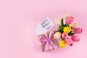 Sticker - Mother day background with tulip flowers bouquet, gift box with pink ribbon and Happy Mother Day tag. Greeting card background, flat lay for poster, brochures, booklets, promotional materials, website