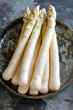 cooked white asparagus with ham and sauce. AI generative.
