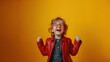 A photo of a cheerful little boy wearing a red leather jacket and glasses is in a good mood. In empty space isolated on yellow background