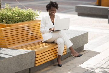 Sticker - happy african businesswoman working with laptop	