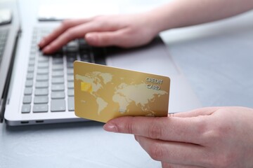 Canvas Print - Online payment. Woman with laptop and credit card at white table, closeup