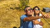 Fototapeta Koty - Father and daughter looking at the sun during a solar eclipse on a country park, family outdoor activity
