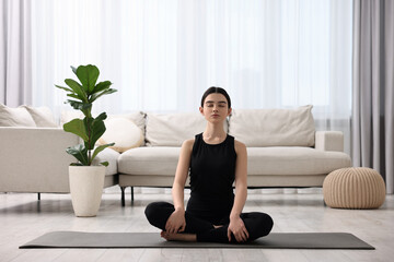 Sticker - Beautiful girl meditating on yoga mat at home