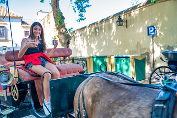 Poster - Young girl riding a horse carriage in Spain