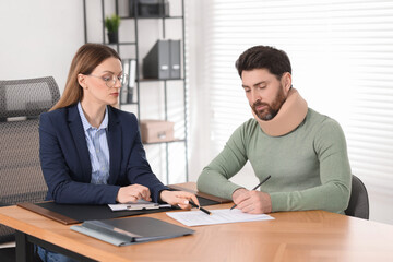 Sticker - Injured man signing document in lawyer's office