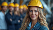 businesswoman wearing safety helmet with colleagues behind