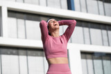 Fototapeta Kuchnia - Middle aged woman doing fitness workout, standing in activewear with abs and muscles, smiling happy,