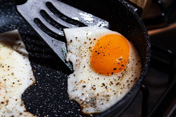 breakfast preparation, fried egg in a frying pan, top view