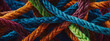 Artistic depiction of a team's interconnectedness, portrayed through a network of strong ropes intertwining to support each other, with a colorful background.