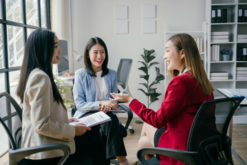 Poster - Three women are sitting in a room, smiling and talking to each other