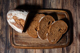 Fototapeta Mapy - sliced rye bread on a wooden cutting board, top view