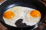 Fototapeta Mapy - two fried eggs in a frying pan
