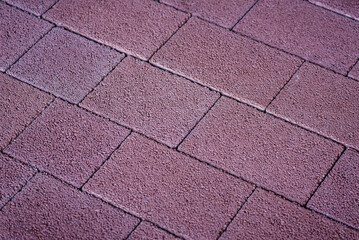 Sticker - The concrete paver features a unique and intricate pattern in a vibrant purple color, adding a touch of personality and charm to any environment.