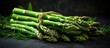 A stack of fresh green asparagus, a popular vegetable ingredient in cuisine, sitting on a table. Asparagus is a terrestrial plant known for its unique taste and versatility in various dishes