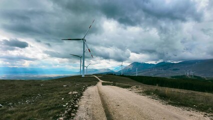 Wall Mural - Wind farm or wind park at sunset located in the mountains of Italy Europe to realize clean energy. It’s sustainable, renewable energy for enviromental. Iconic location for landscape photographers blog