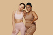 © DragonImages - Portrait of happy friends with different body types posing before working out together