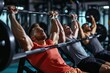 A group of men engaging in various workouts and exercises at a modern gym, A trio doing a bench press in synchronization at the gym, AI Generated