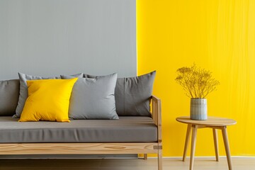 Scandinavian interior design of modern living room, home. Cozy sofa with grey and yellow pillows and side table near yellow and grey wall with copy space.