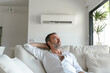 Summer and air conditioning. middle-aged Caucasian man enjoying the coolness of the air conditioner in his modern home..