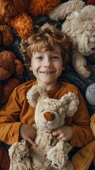 Wall Mural - Happy young boy surrounded by his stuffed animals shot from above.