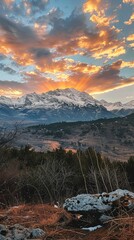 Wall Mural - Idyllic view of snowcapped mountains against dramatic sky