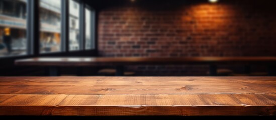 Canvas Print - A brown hardwood plank table is in the foreground, with a brick wall in the background. The wood stain complements the flooring