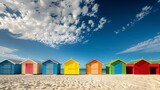Fototapeta  - A row of vibrant beach huts sits atop a sandy beach, adding a pop of color to the shoreline.