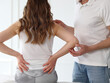 Woman suffering from low back during medical exam. Chiropractic, Osteopathy, Physiotherapy concept.