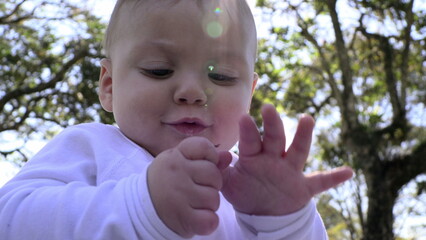 Canvas Print - Cute baby at outdoor park feeling happy discovering exploring the world