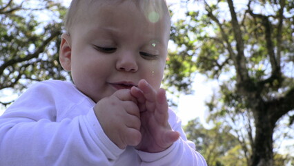 Canvas Print - Cute baby at outdoor park feeling happy discovering exploring the world