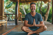 Smiling male yogi enjoys a tranquil meditation session on a serene outdoor pavilion