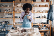 © Zamrznuti tonovi - Interracial craftswoman at pottery workshop decorating clay work.