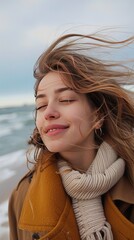 Wall Mural - Young women feel winter wind on the beach