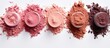 A display of various shades of blush, resembling a row of petals on a white canvas, creating an artistic circle on the surface