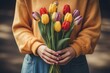 Women hands are holding a bouquet of tulips. International Women Day 8 march