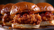 a close-up of three fried chicken sandwiches with a glossy bun, showing the crispy chicken and sauce in detail.