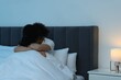 Woman suffering from headache in bed at night