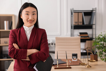 Poster - Portrait of smiling notary with crossed arms in office. Space for text