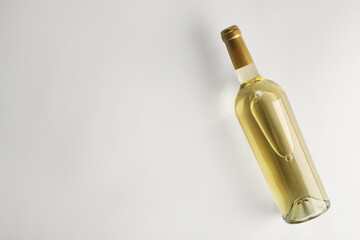 Canvas Print - Bottle of expensive white wine on light background, top view. Space for text