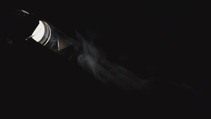 Wall Mural - Close-up of smoke moving in spotlight. Media. Single spotlight light in dark with smoke. Beautiful streams of smoke move with spotlight