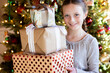 © Rachel Weill - Child with holiday presents in front of Christmas Tree