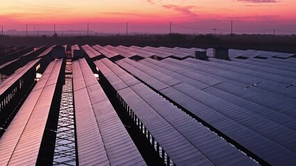 Wall Mural - Aerial video of solar panel industry scene at dusk, green energy concept. Photovoltaic power station on water. Drone forward shooting.