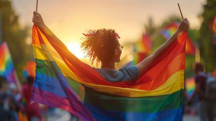 A woman joyfully waves a rainbow flag at a pride parade, celebrating love, acceptance, and unity within the LGBTQ+ community