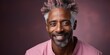Senior african american man with grey hair. happy and positive, smiling confident at camera. Pink background