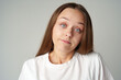 © fotofabrika - Clueless young worried woman dont know what to say, has no answer on gray background