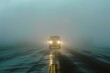 A car driving on the highway in thick fog, headlights visible. Dense mist. Wet asphalt. Humidity. Foggy empty road. A vehicle with headlamps on approaching on a misty road. Low visibility