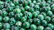 pile of emerald marble balls pearls with some skulls