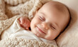 Smiling newborn baby sleeping on a blanket.